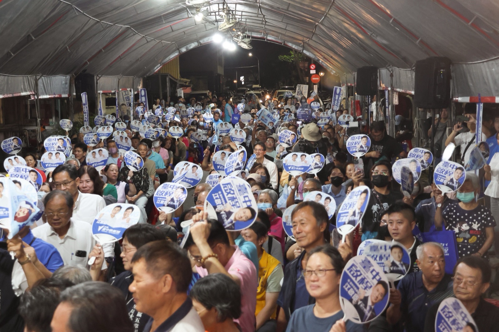 夜間帳棚下座無虛席，鄉親舉著印有「臺中啟程 江啟臣」的競選扇聆聽